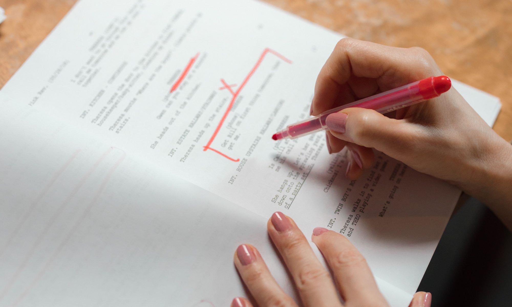 a person proofreading and editing a document.