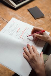 a person proofreading and editing a document.